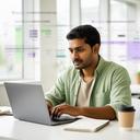 SaaS founder Baheru Bhuiyaan reviewing model costs at a desk in a bright startup workspace